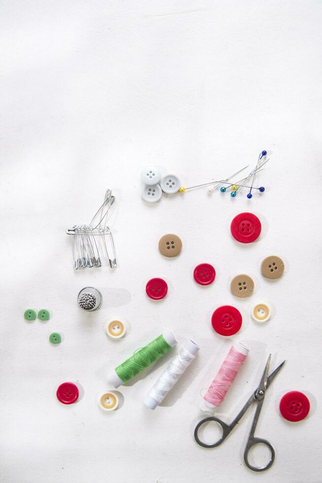 a pile of buttons on a white table photo