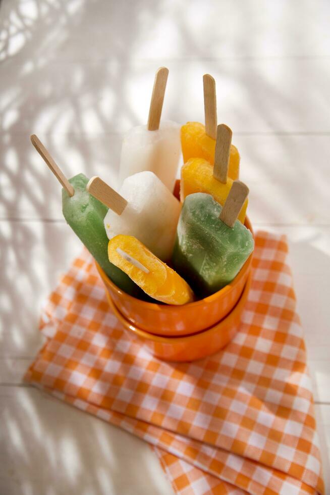 ice pops on a plate with orange and green stripes photo