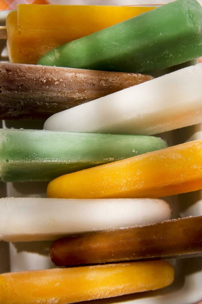 ice pops on a plate with orange and green stripes photo