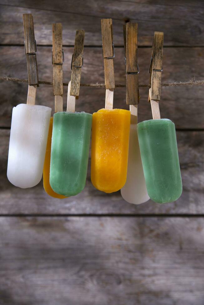 a line of popsicles hanging on a clothesline photo