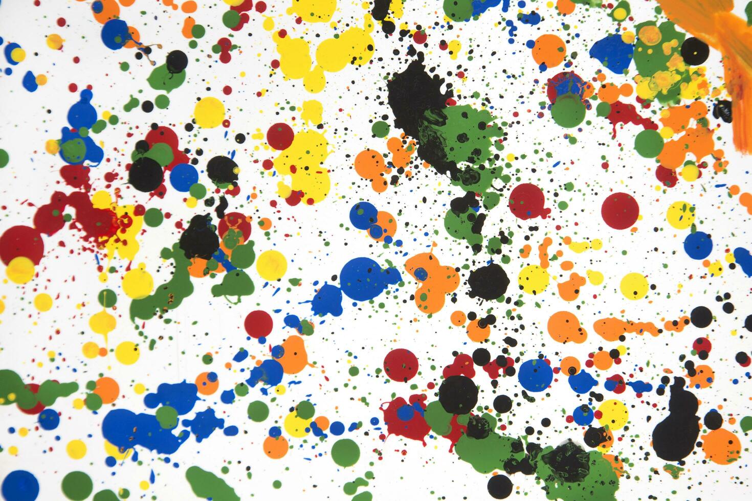 a colorful paint splattered surface with many different colors photo