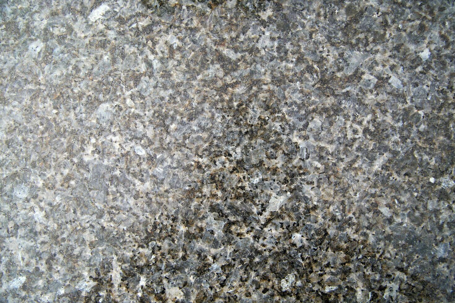 a close up of a granite surface with some black spots photo