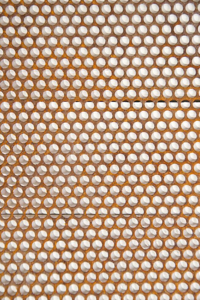 a close up of a metal mesh with holes photo