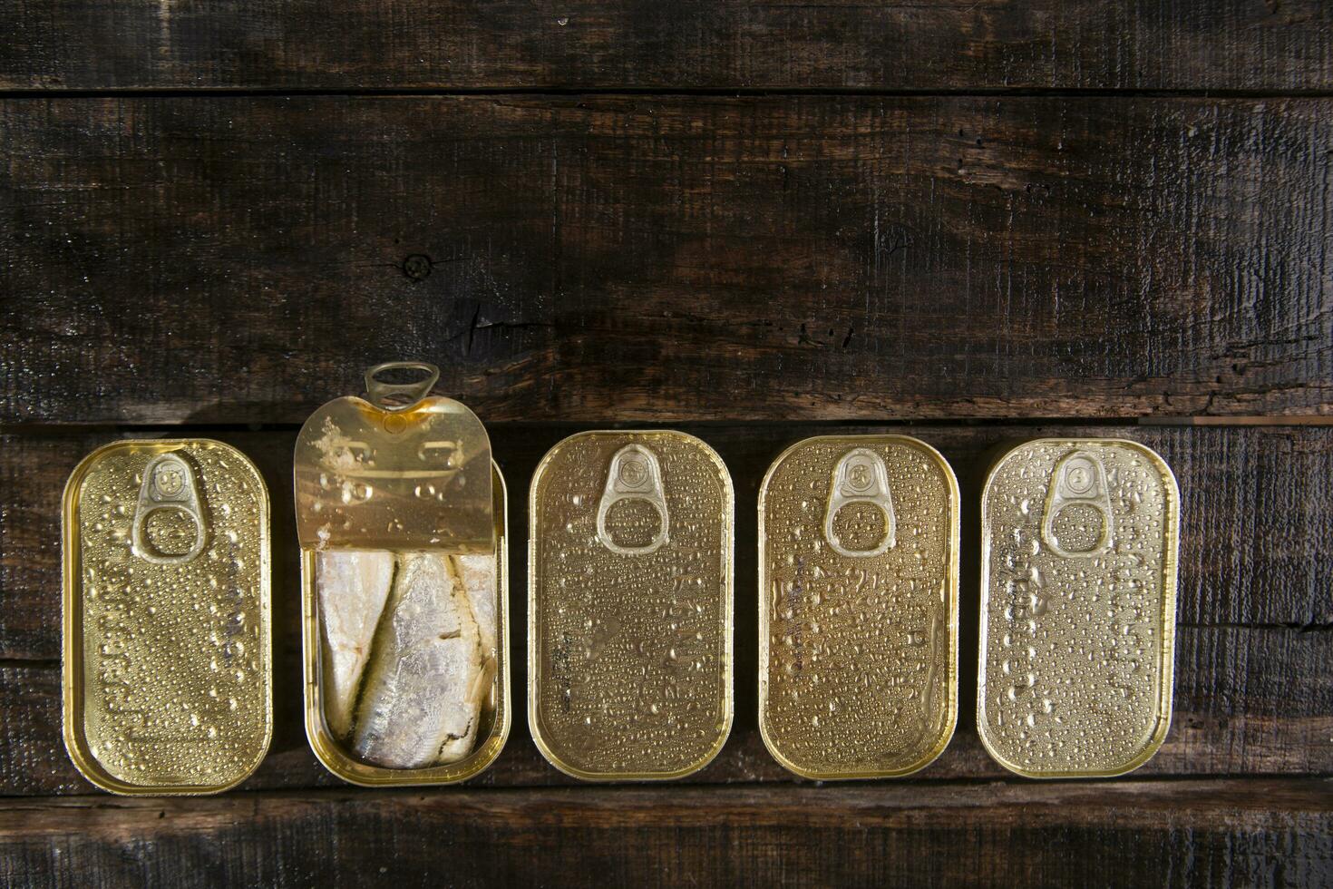 a row of gold coins on a wooden table photo