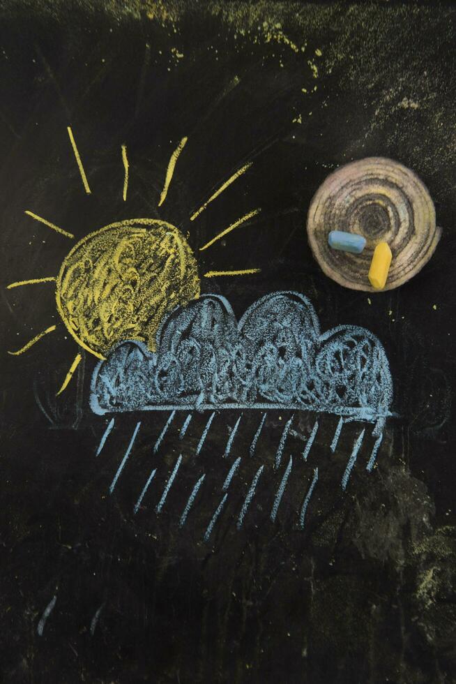 a chalk drawing of a cloud and snow on a blackboard photo