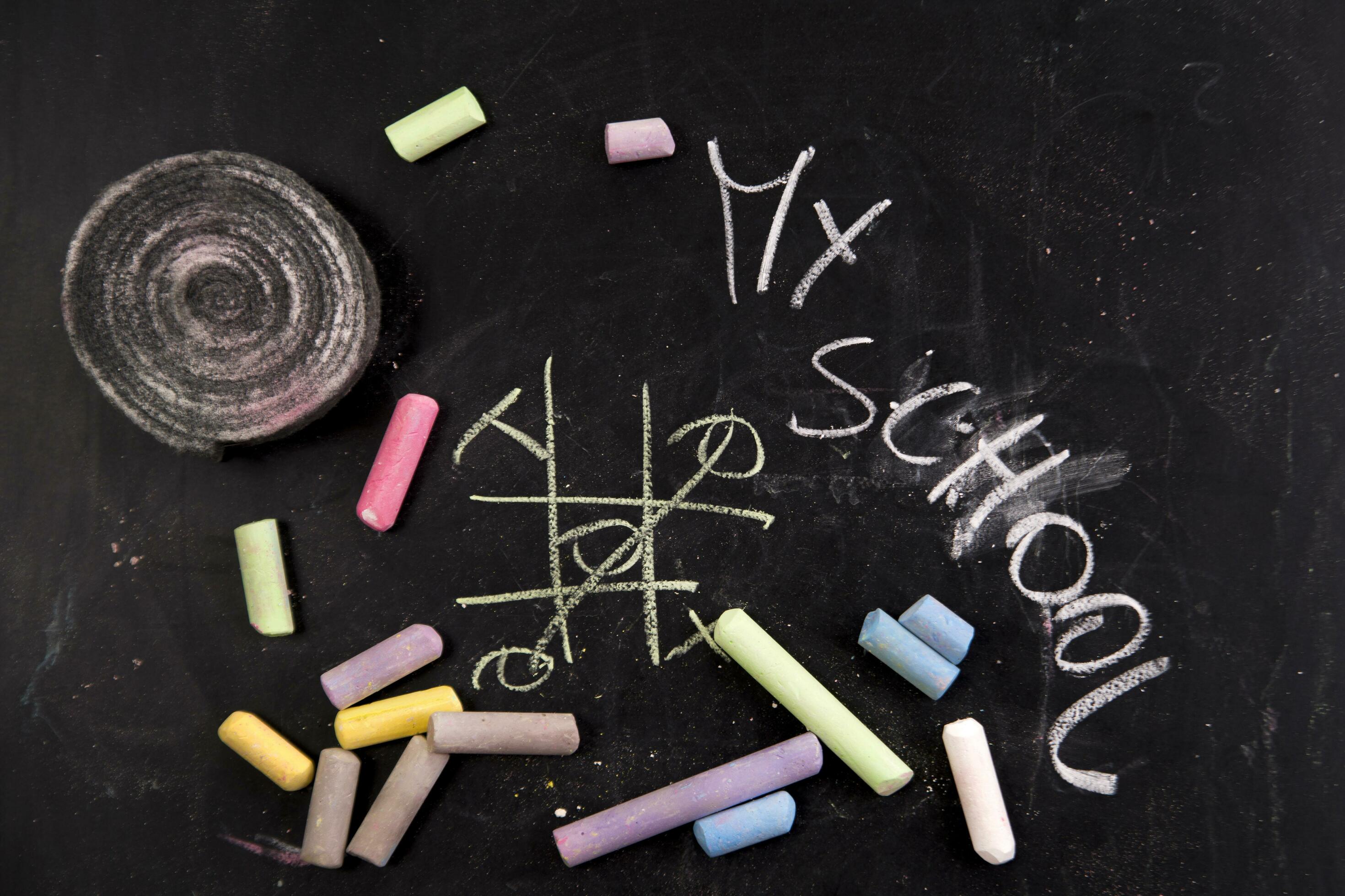 chalk and crayons on a blackboard stock photo 27082935 Stock Photo at Vecteezy
