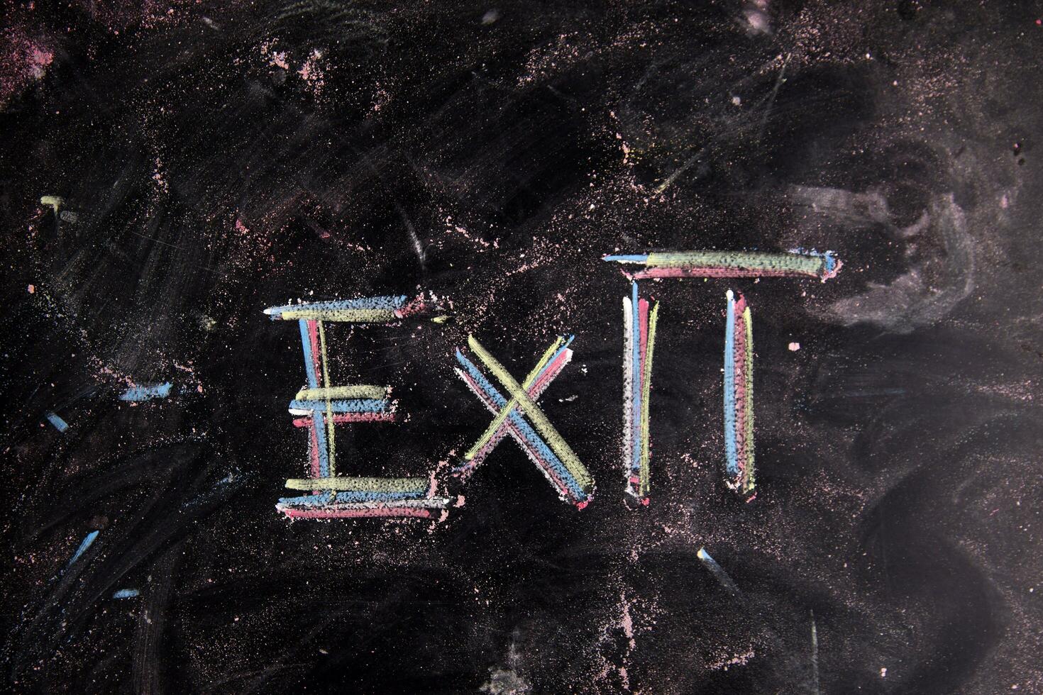 exit sign on blackboard with arrows photo