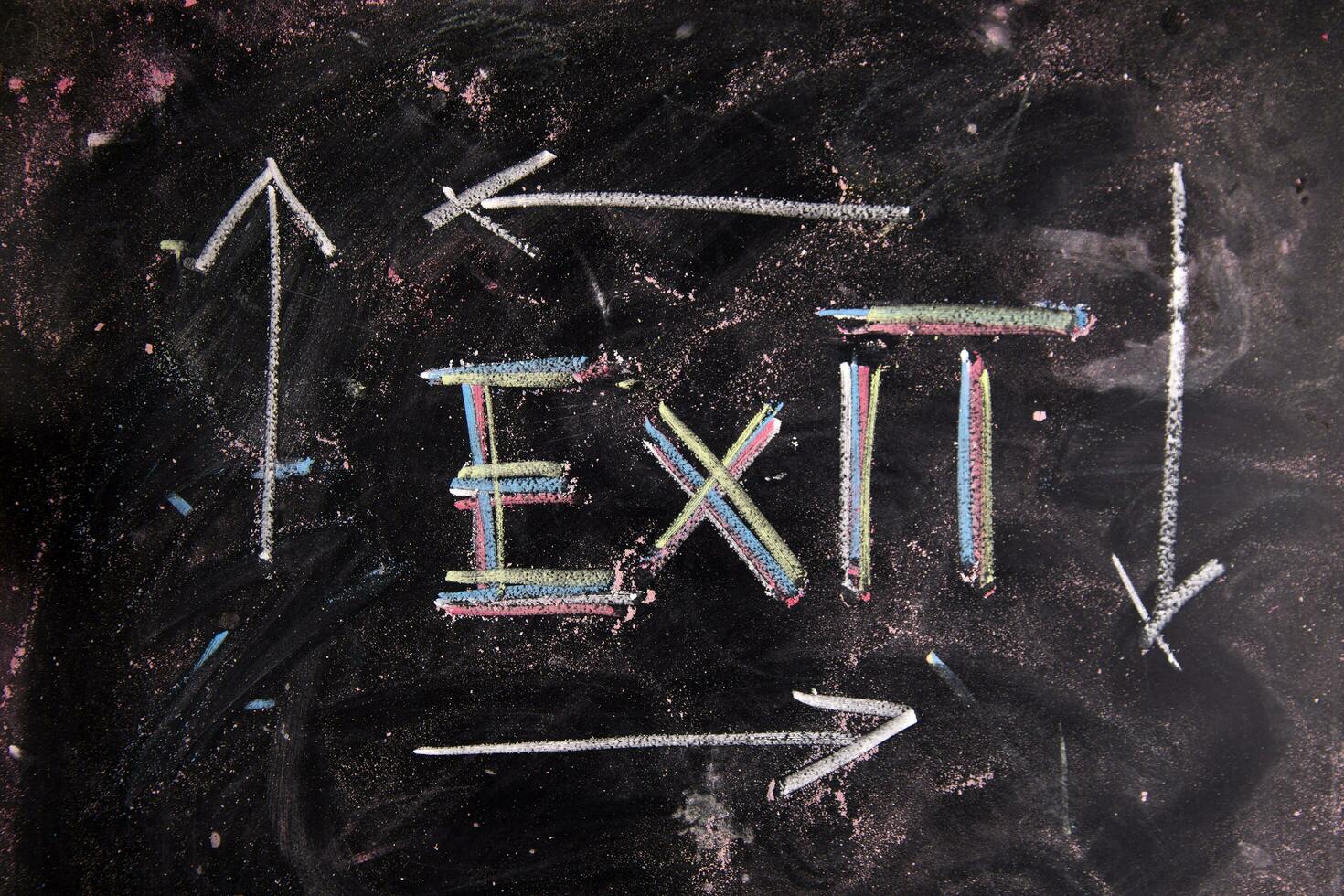 exit sign on blackboard with arrows photo