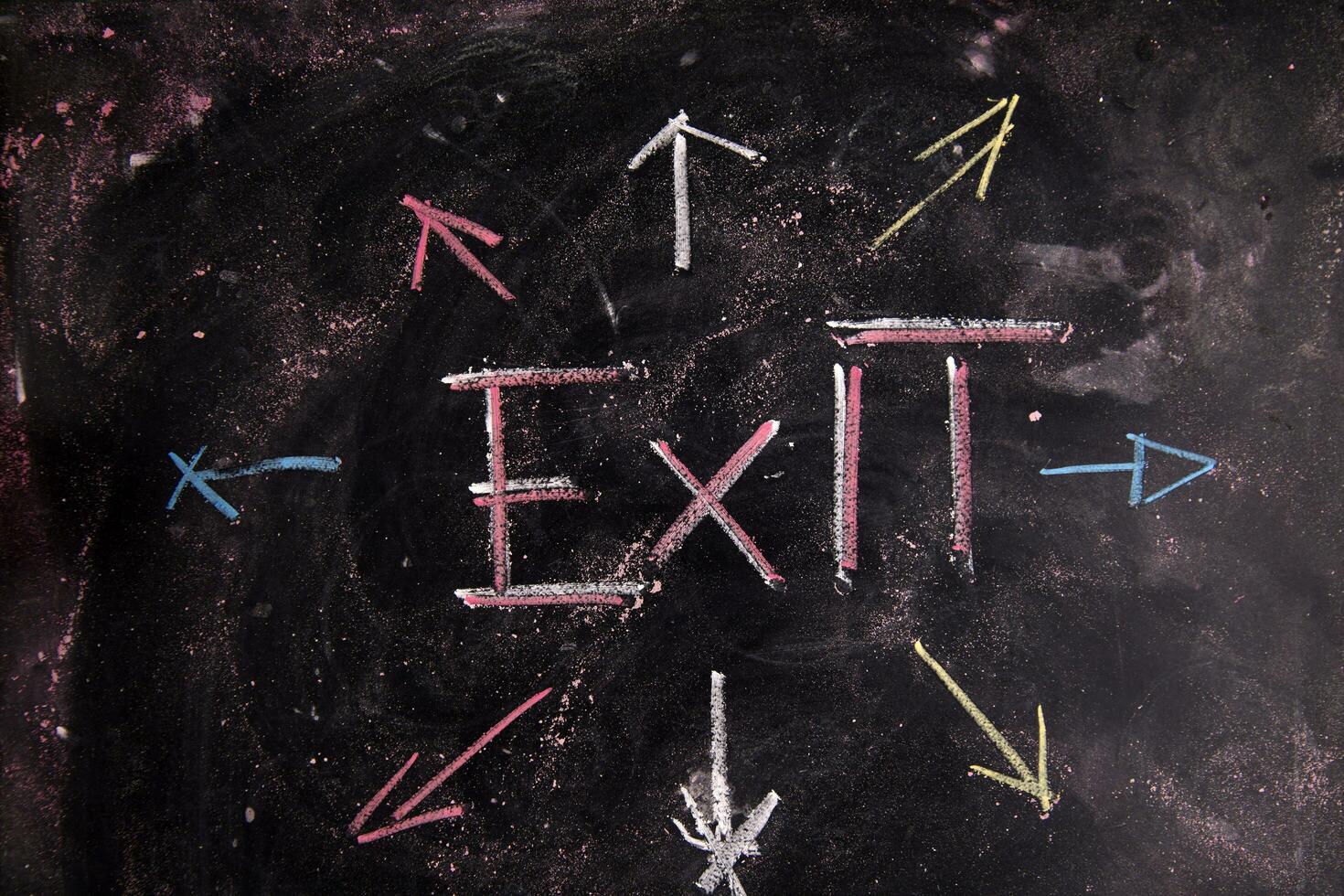 exit sign on blackboard with arrows photo