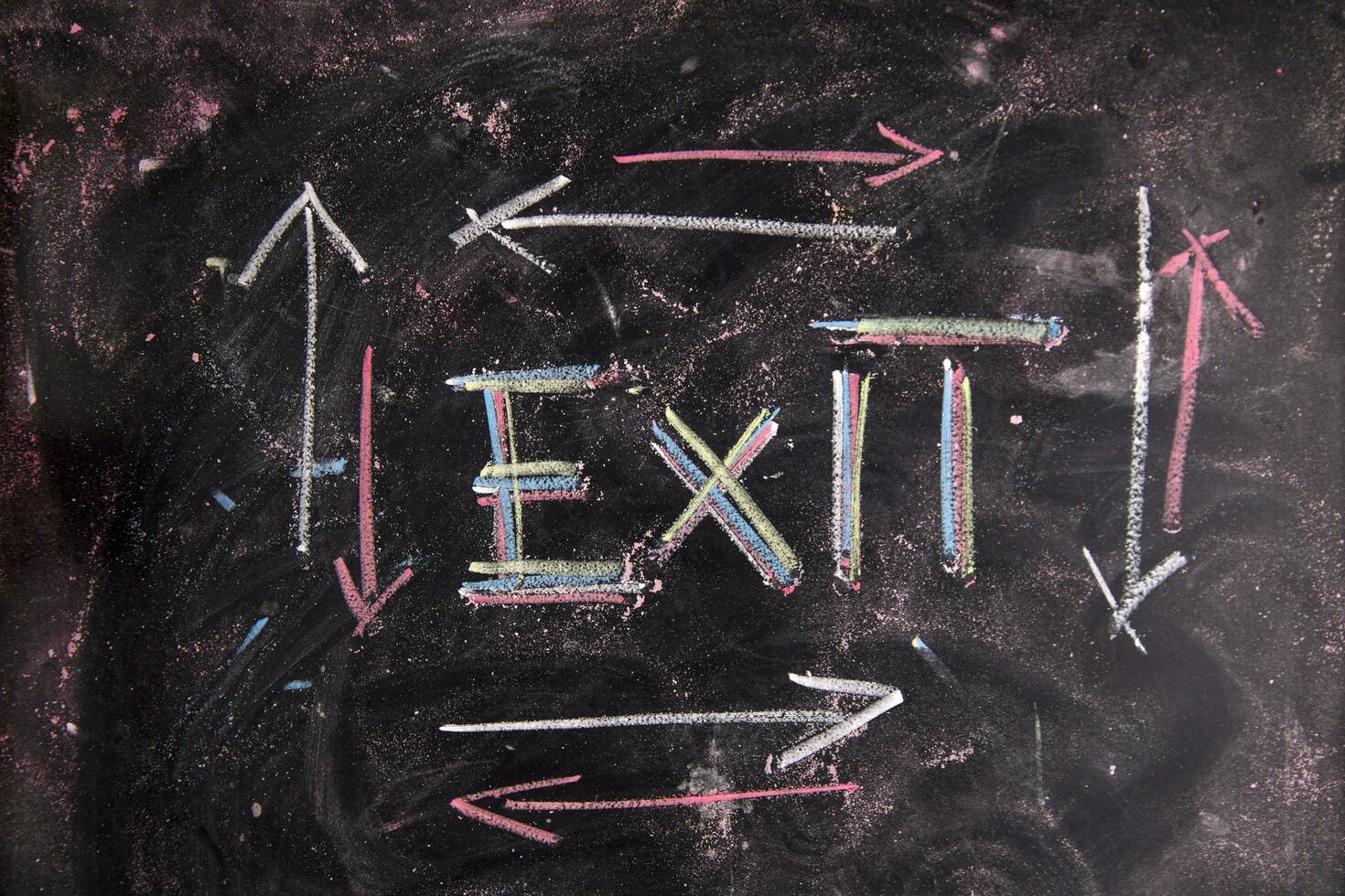 exit sign on blackboard with arrows photo