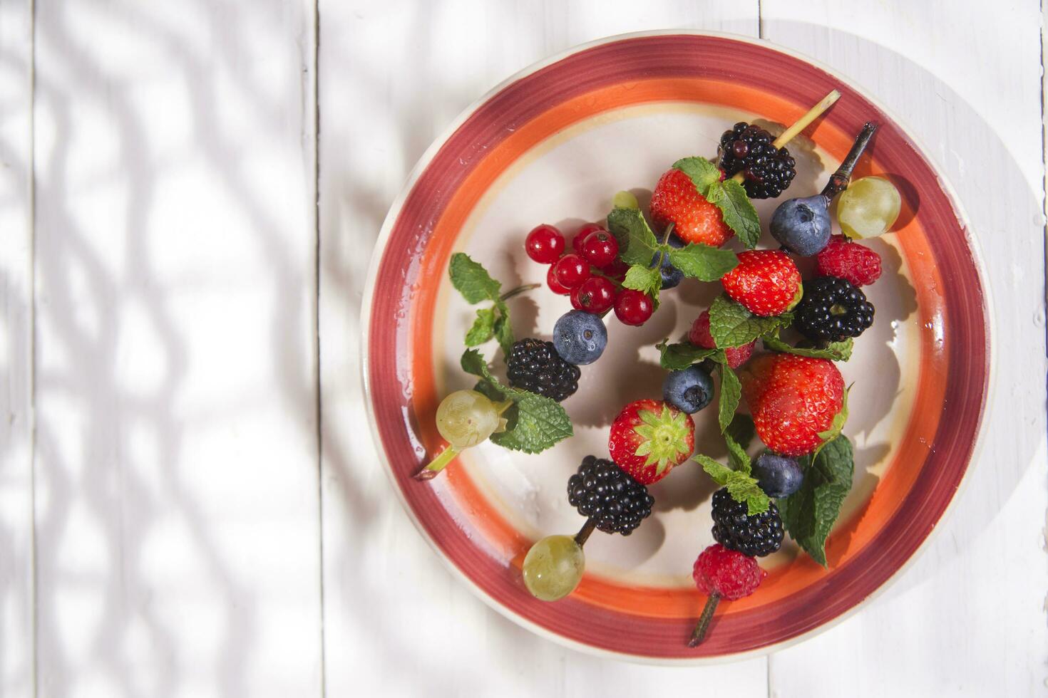 Skewer of berries in pot photo