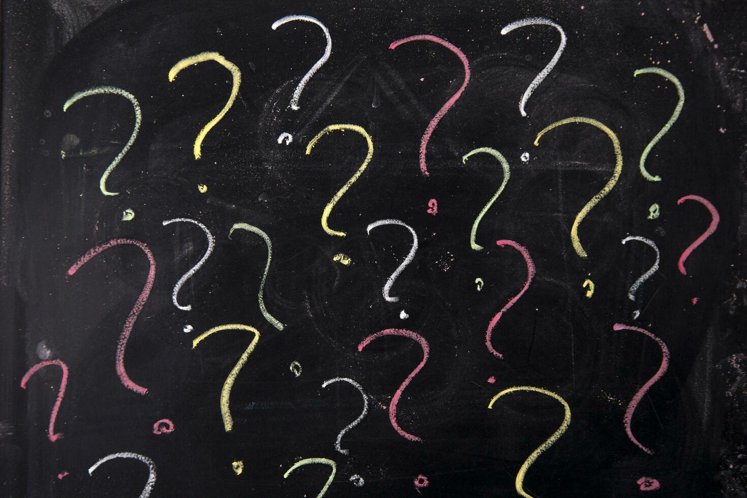 a chalkboard with question marks and a hat photo