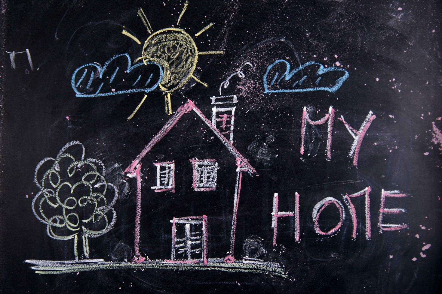 a chalkboard with a house, a sign and a sun photo