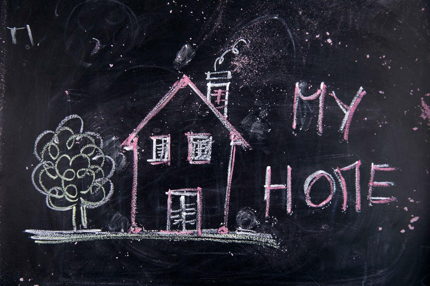 a chalkboard with a house, a sign and a sun photo
