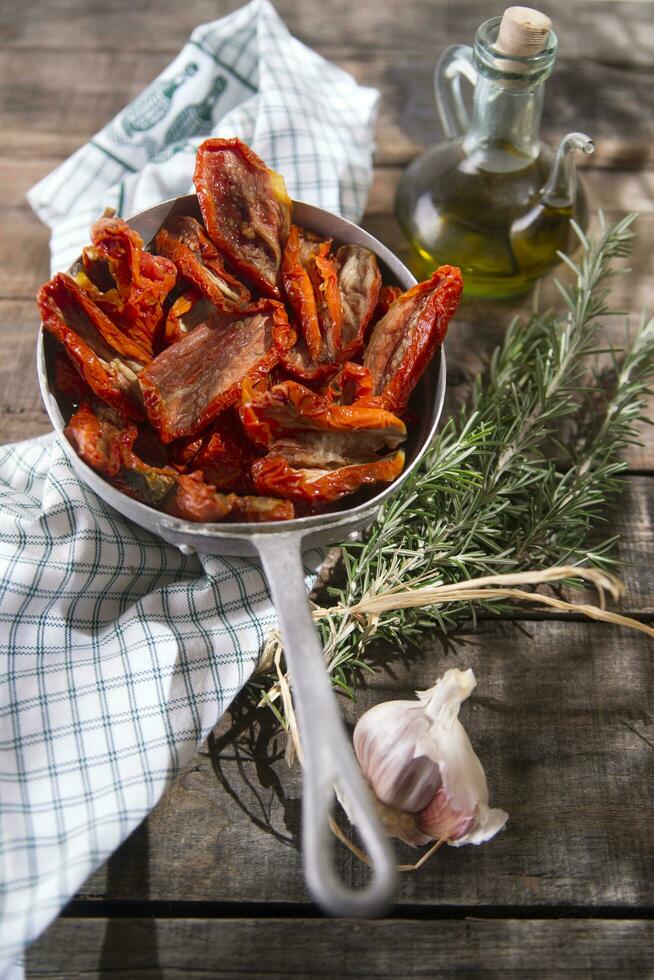 Dried tomatoes with rosemary photo