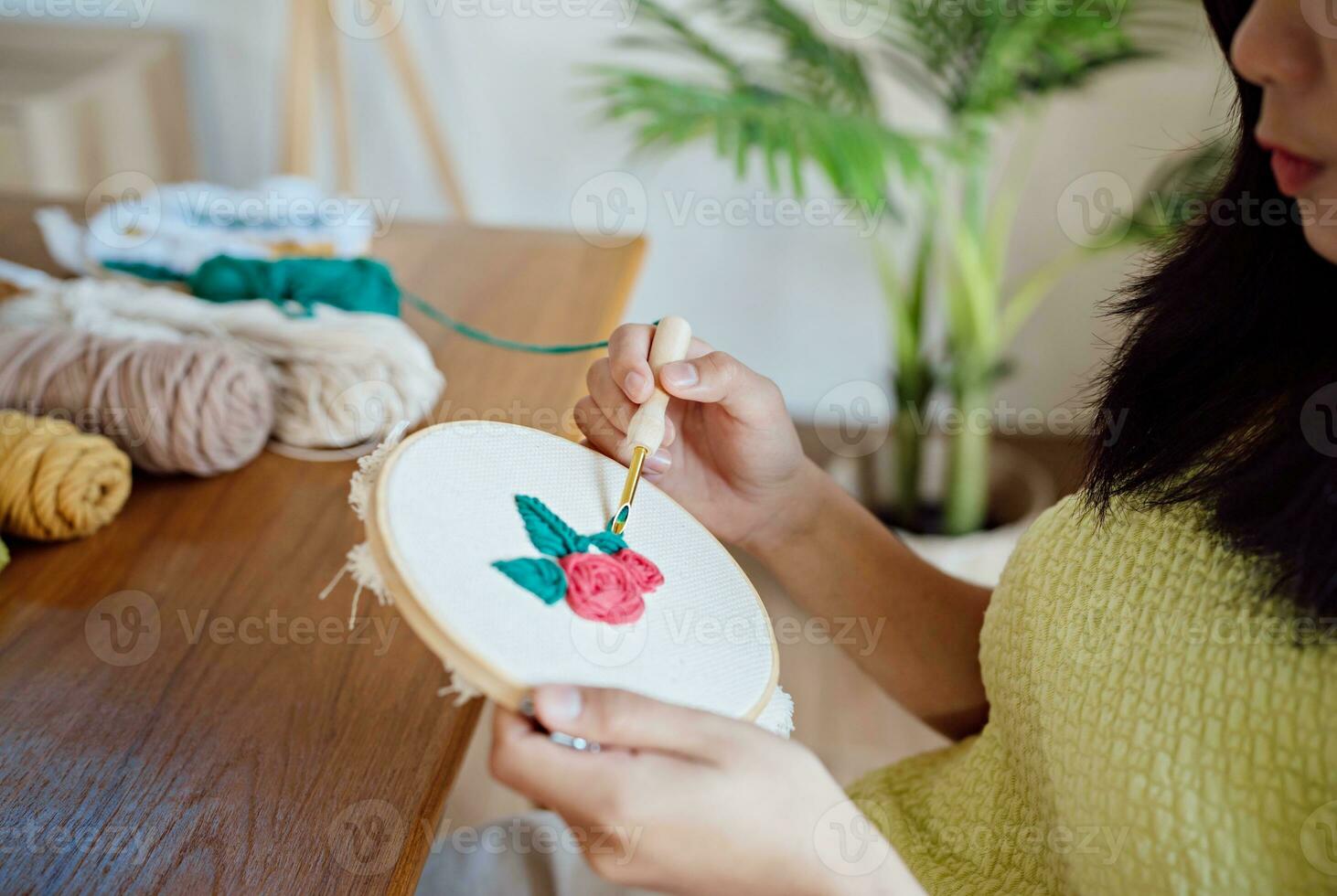 Punch needle. Asian Woman making handmade Hobby knitting in studio workshop. designer workplace Handmade craft project DIY embroidery concept. photo