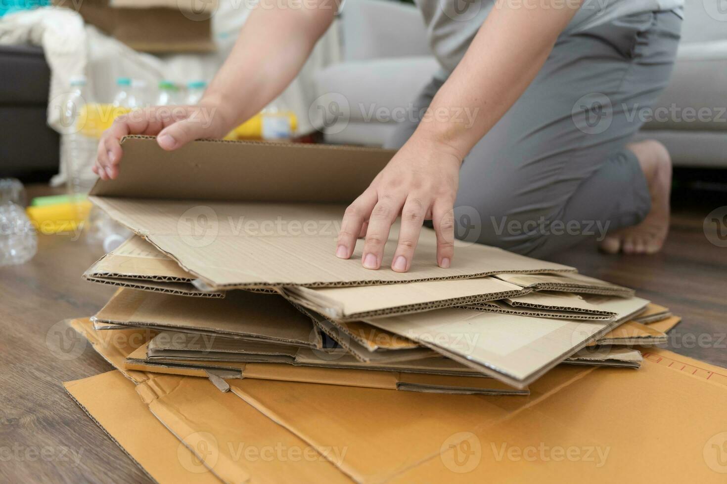 Home recycle eco zero waste concept Man using recycle paper box. Stacking brown cardboard box eco friendly packaging made of recyclable raw materials. photo