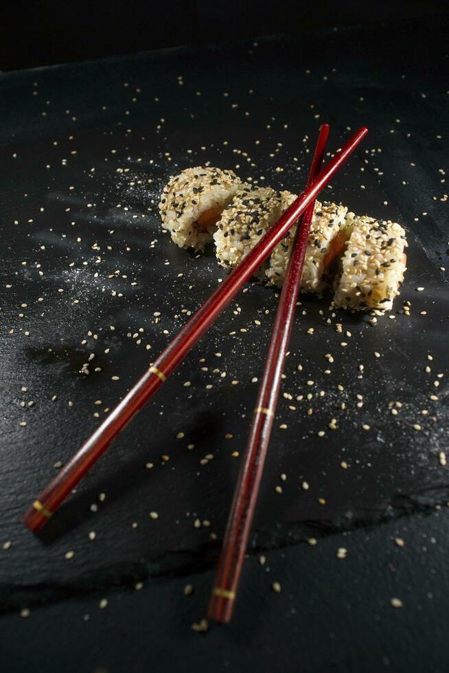 Sushi dish with chopsticks photo