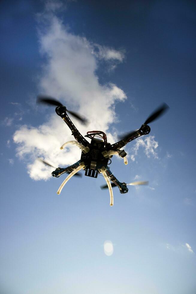 Drone in flight with cloudy sky photo