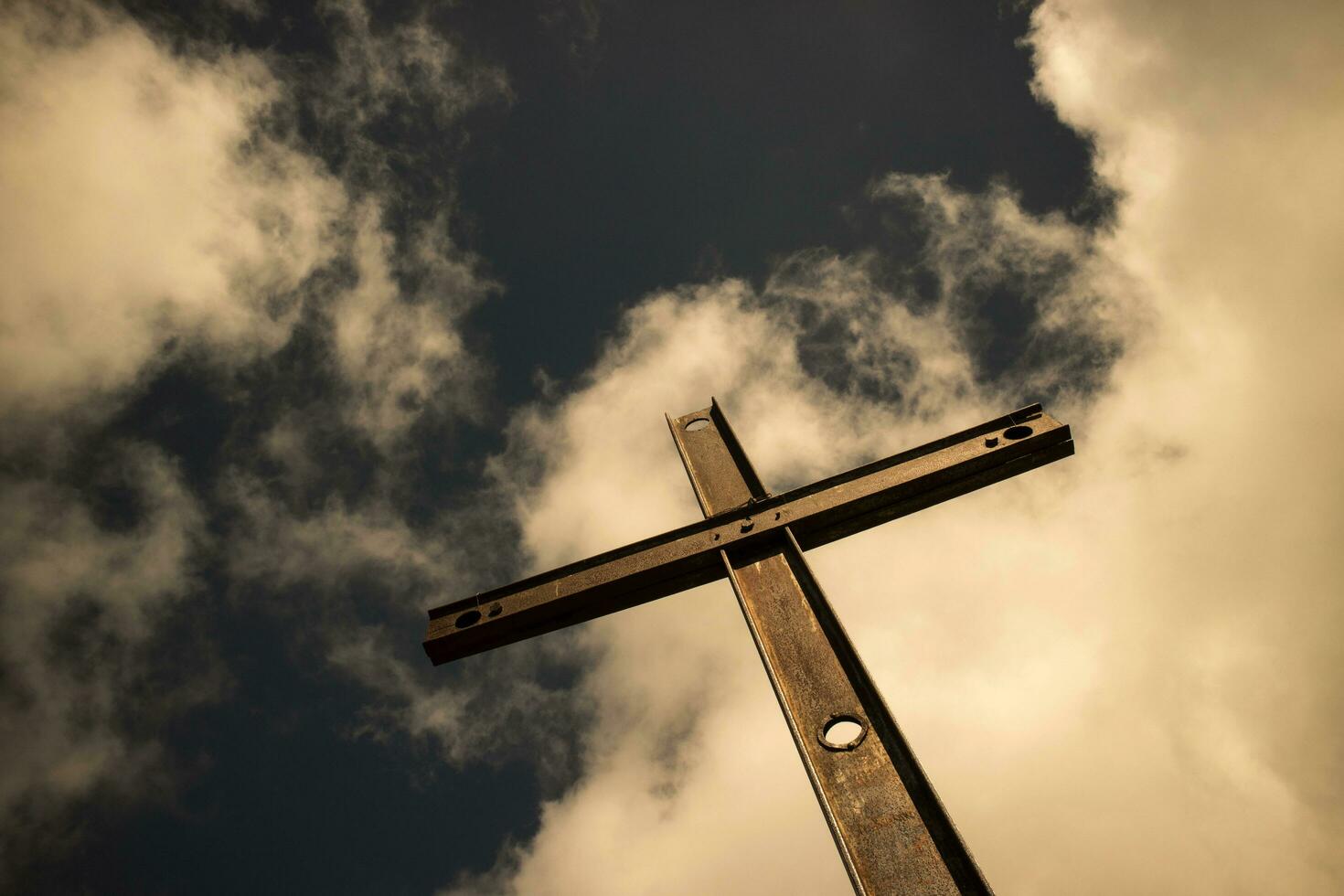 Iron cross and cloudy sky photo