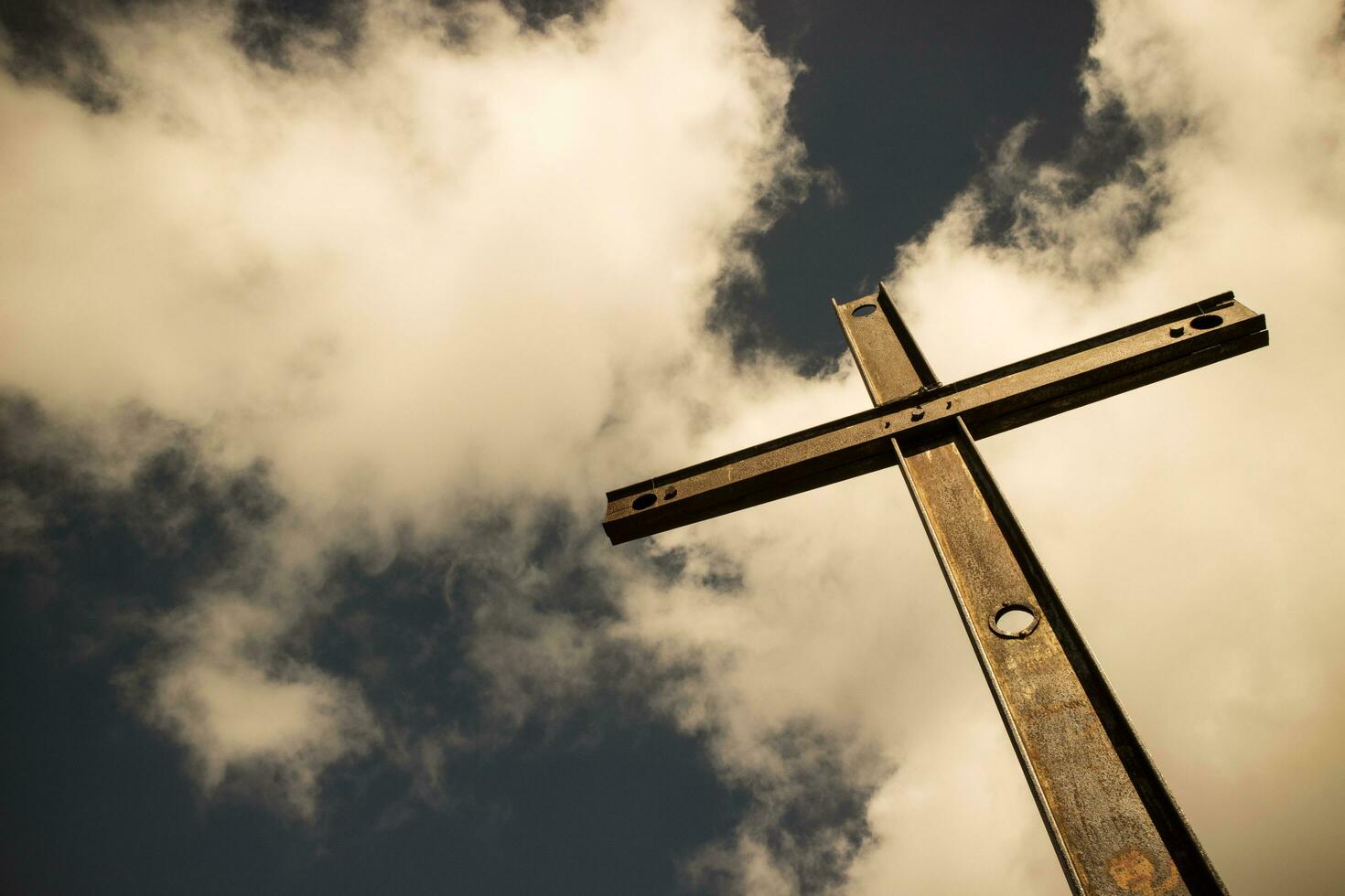 Iron cross and cloudy sky photo