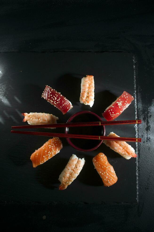 Circular sushi plate with chopsticks photo