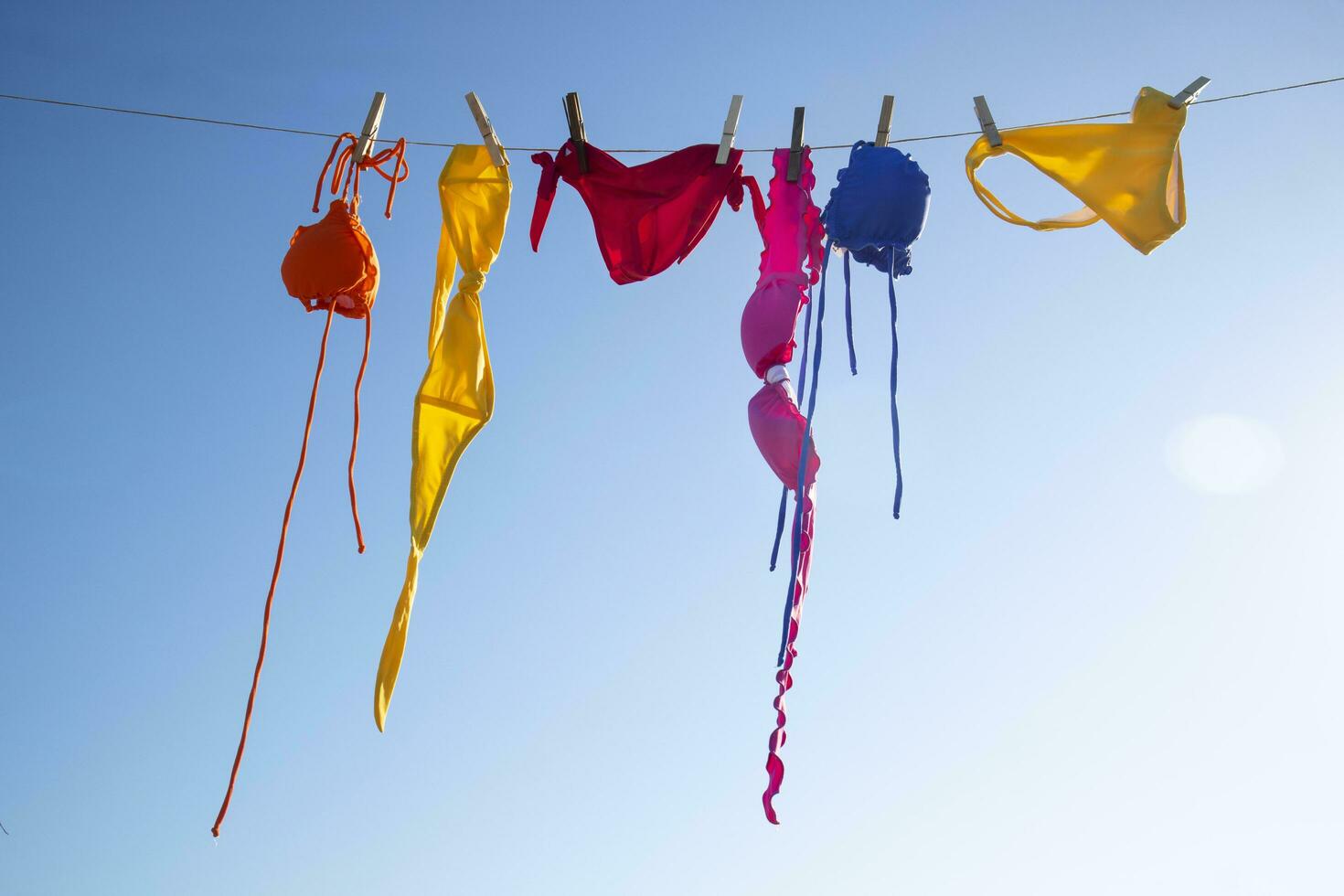 Swimwear of various colors lying in the sun photo