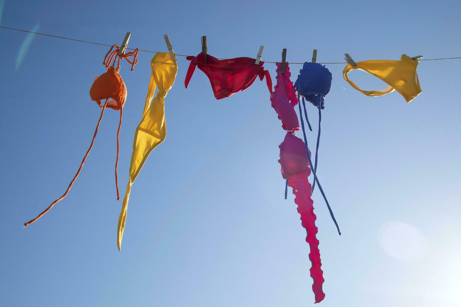 Swimwear of various colors lying in the sun photo