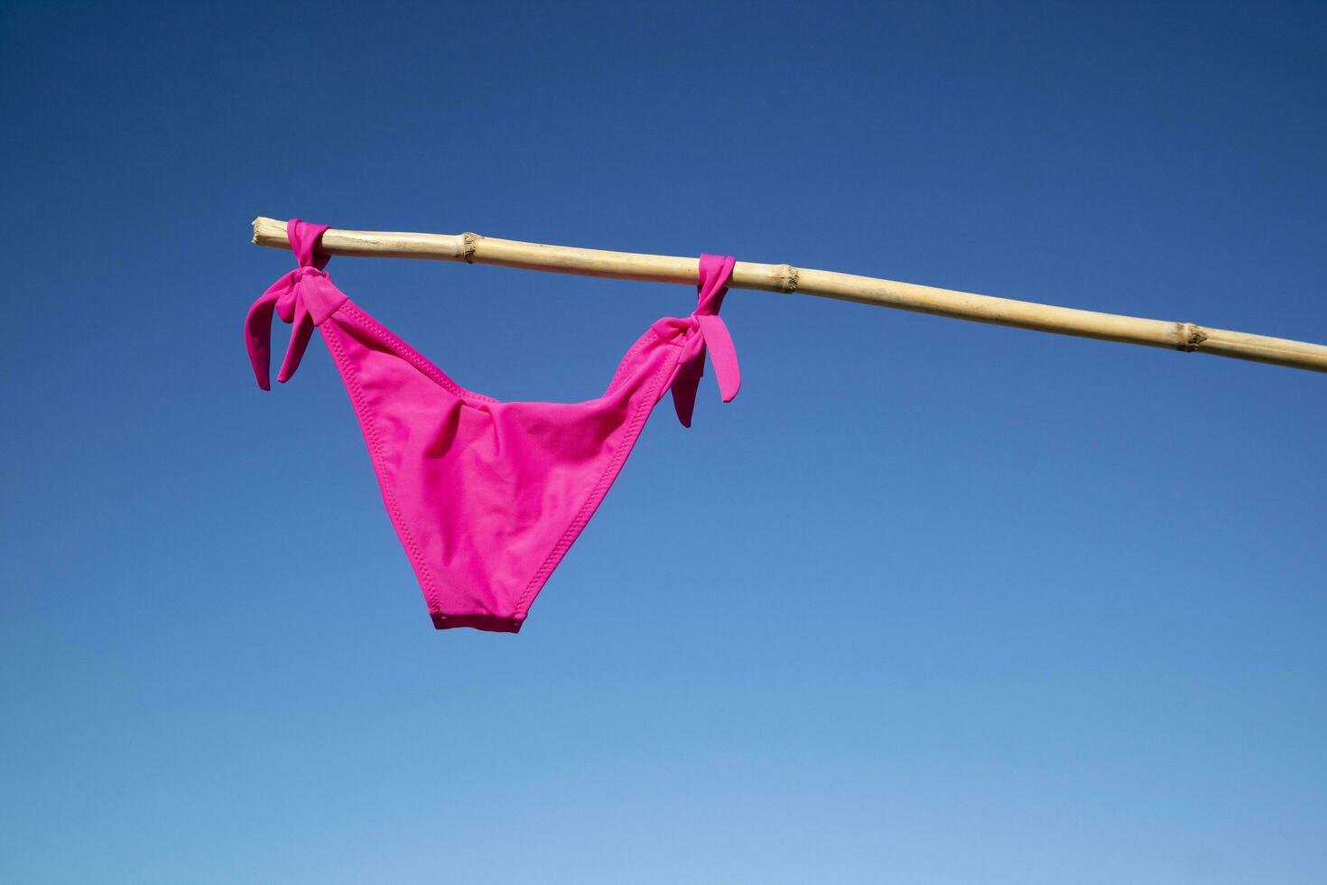 Colorful female swimsuit to dry in the sun photo