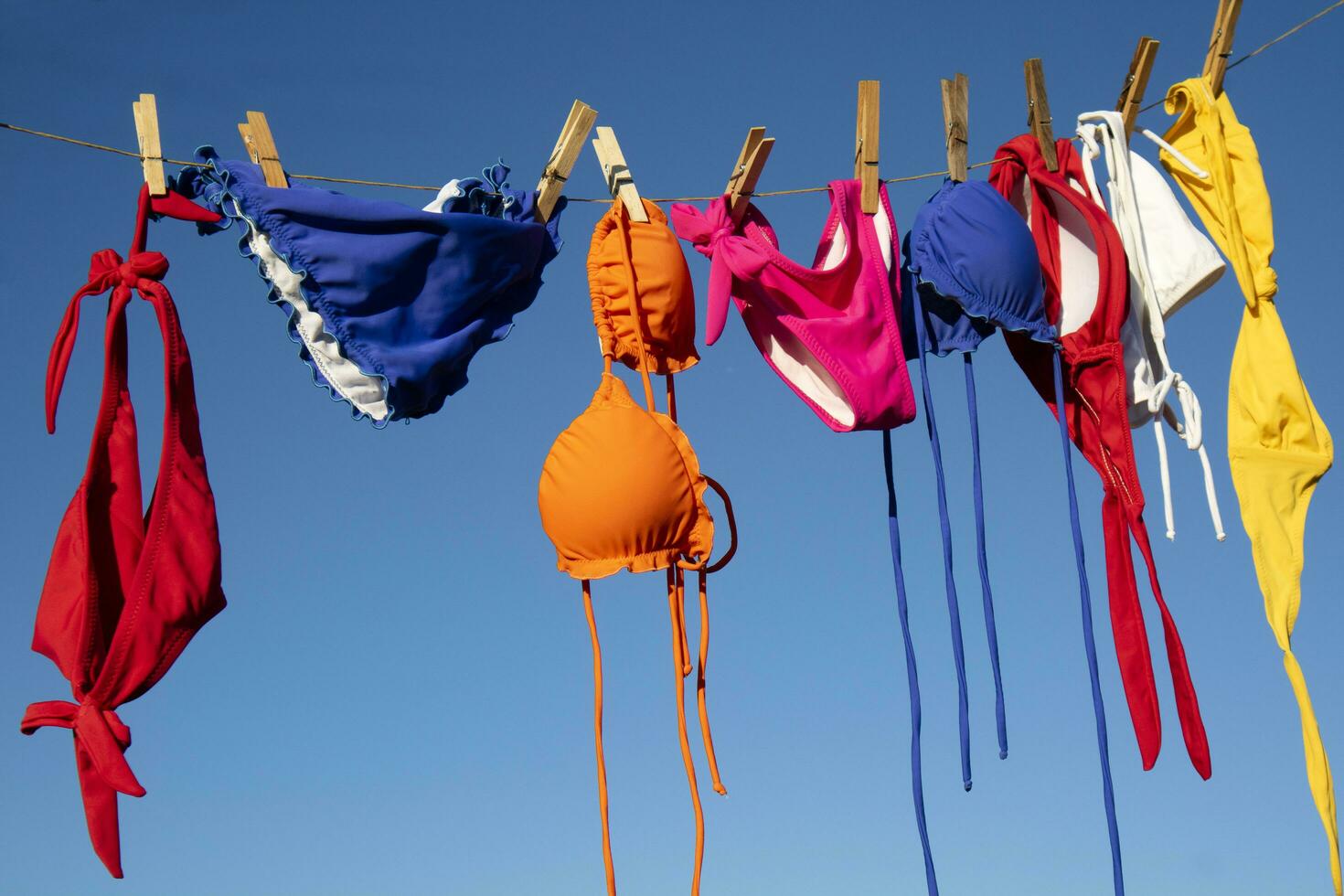 Female swimwear hanging in the sun to dry photo