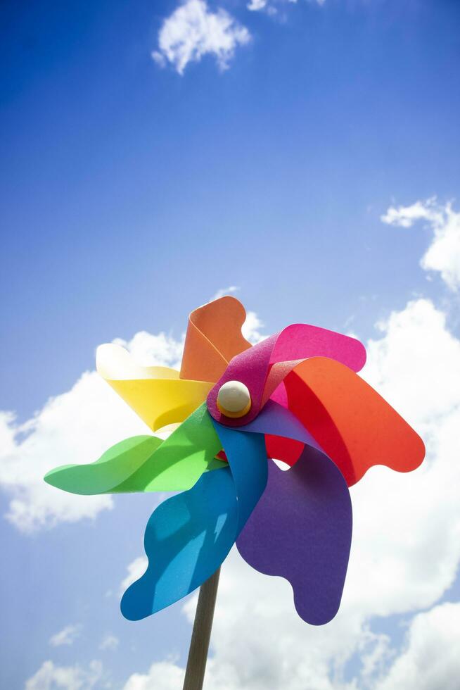 Multicolored pinwheels in the blue sky photo