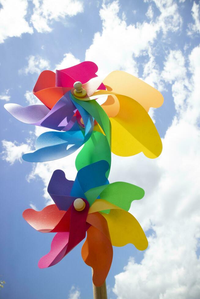 Multicolored pinwheels in the blue sky photo