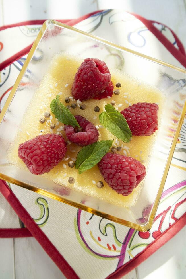 Vegan cooking creme caramel with raspberries photo