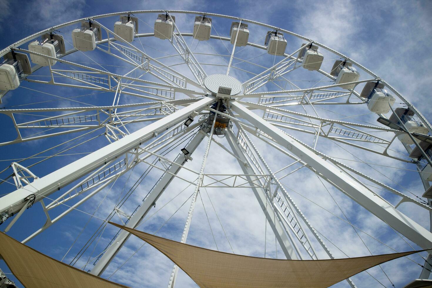 Ferris wheel of white color in blue sky photo