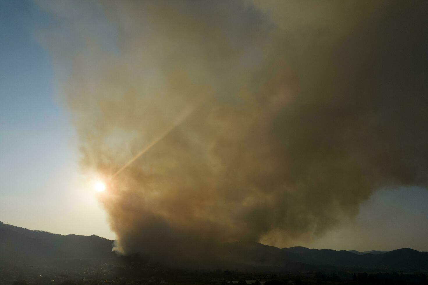 Large column of smoke from a forest fire photo