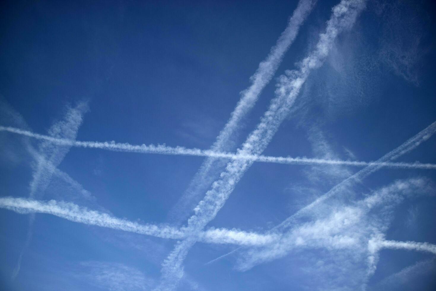 The trails in the sky that leave the planes in flight photo