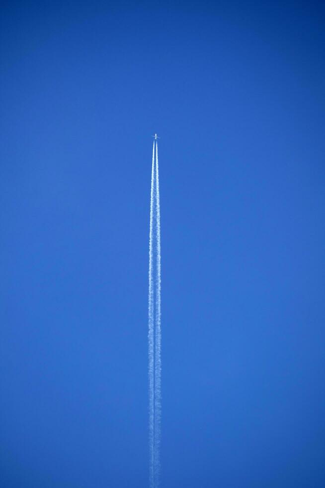 The trails in the sky that leave the planes in flight photo