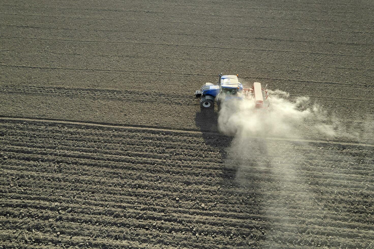 Aerial view of a tractor in the moment of sowing photo