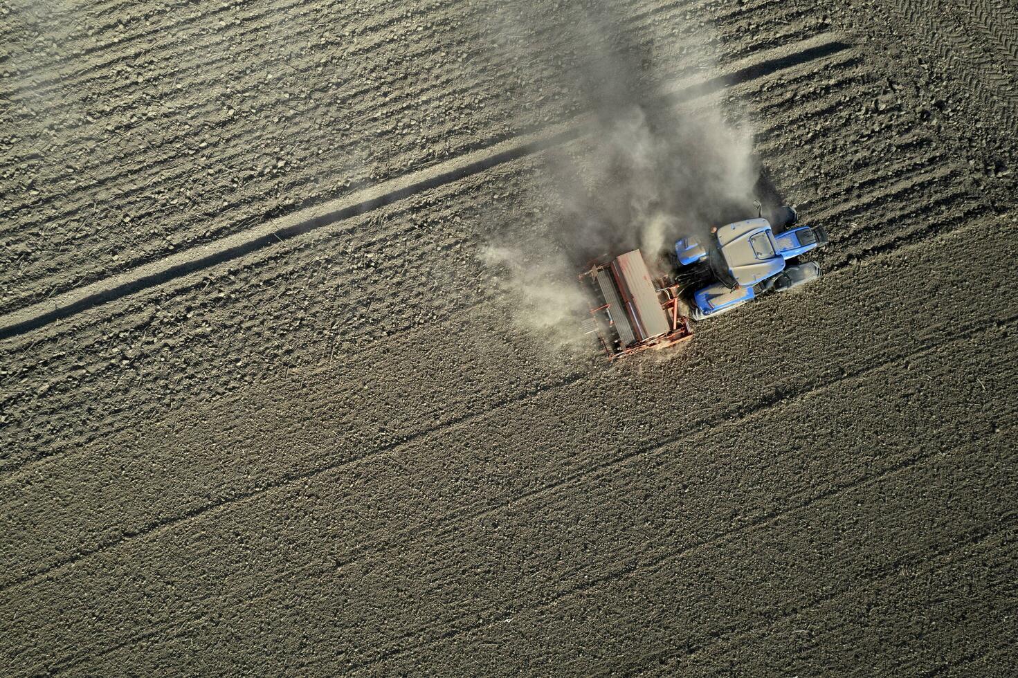Aerial view of a tractor in the moment of sowing photo