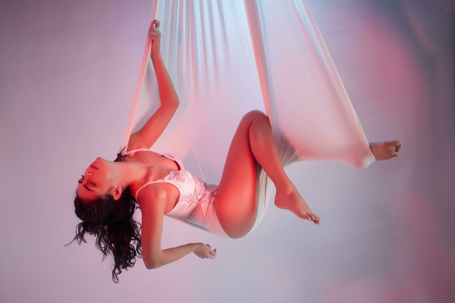 Beautiful young girl relaxing in a white colored hammock photo