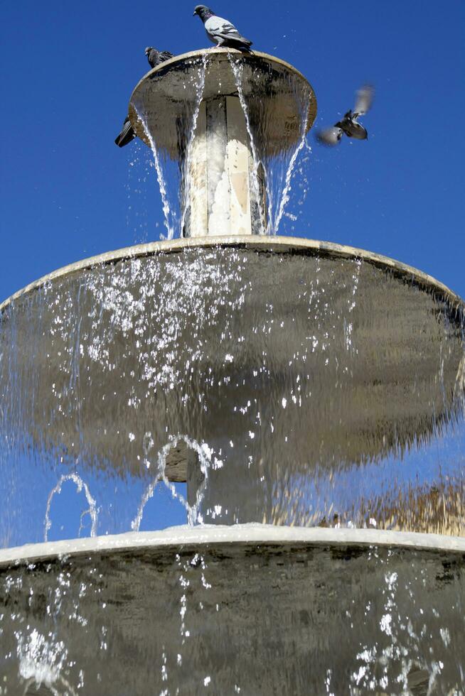 Public fountain in the square of Colle Val D'Elsa Tuscany Italy photo