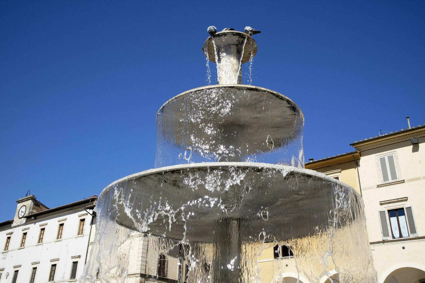 Public fountain in the square of Colle Val D'Elsa Tuscany Italy photo