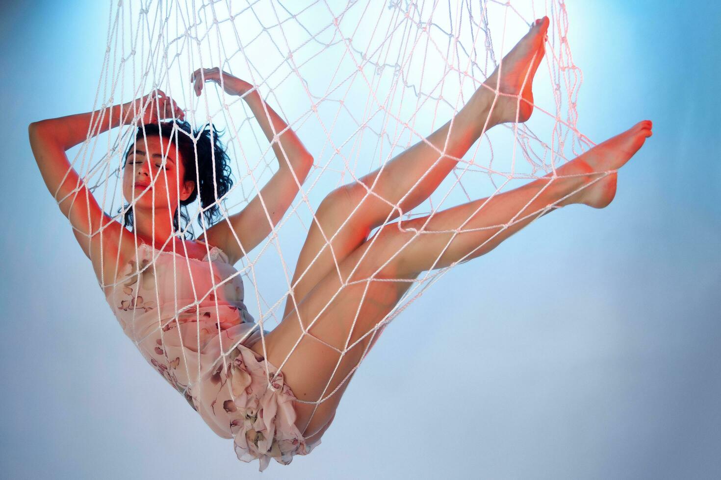 Beautiful girl imprisoned and caught in a net photo