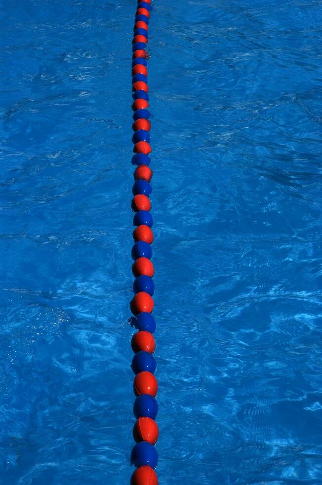 a blue swimming pool with orange and red lines photo