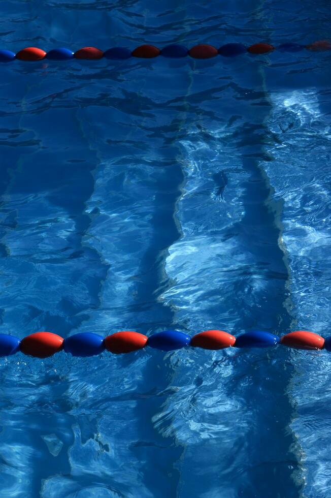 a blue swimming pool with orange and red lines photo