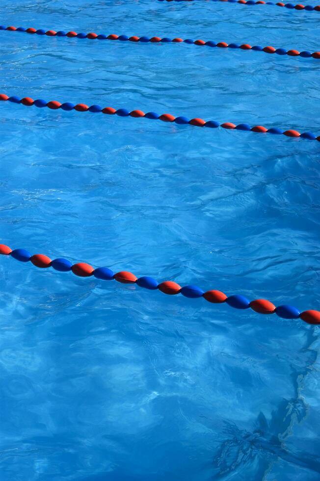 a blue swimming pool with orange and red lines photo