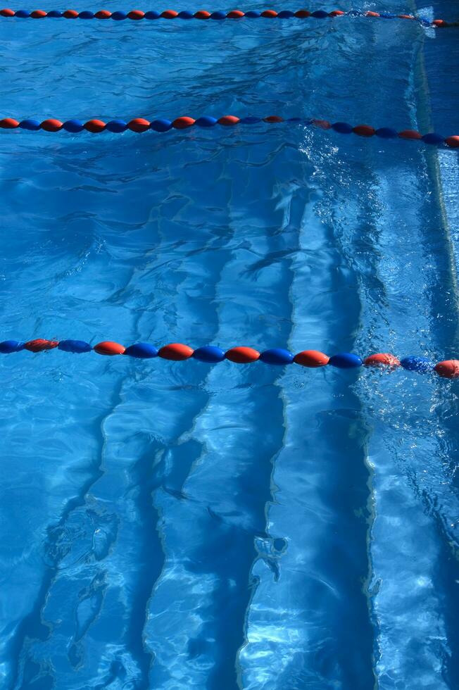 a blue swimming pool with orange and red lines photo