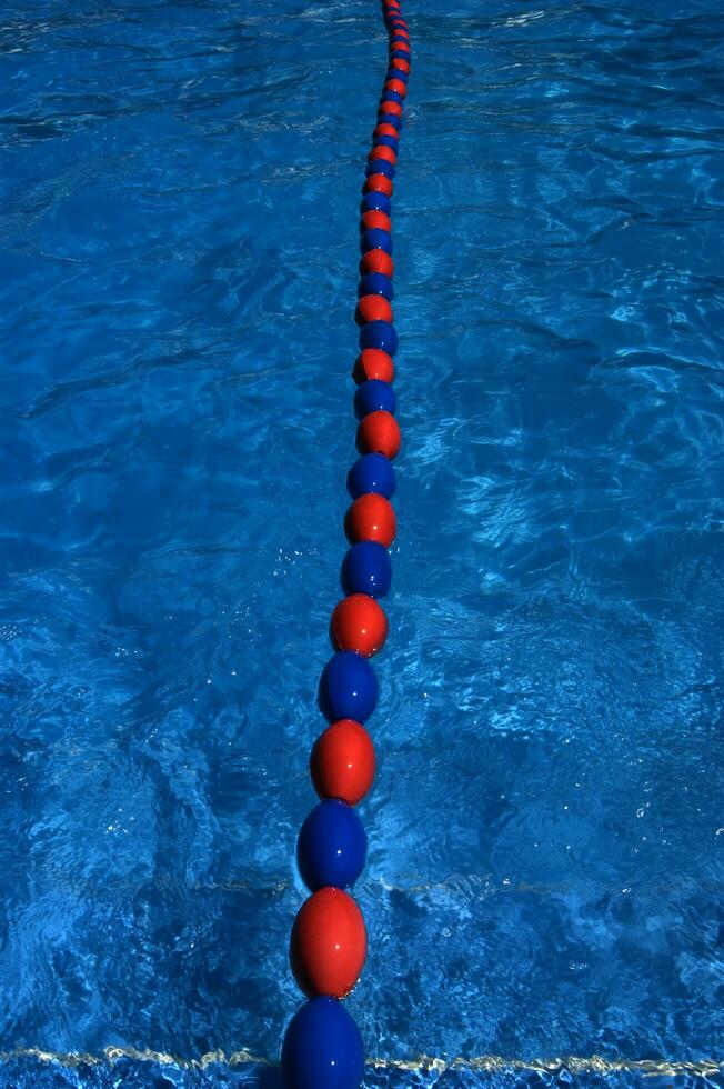 a blue swimming pool with orange and red lines photo