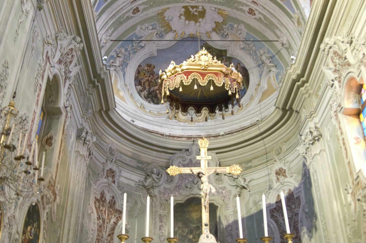 a church with a cross and a gold chandelier photo