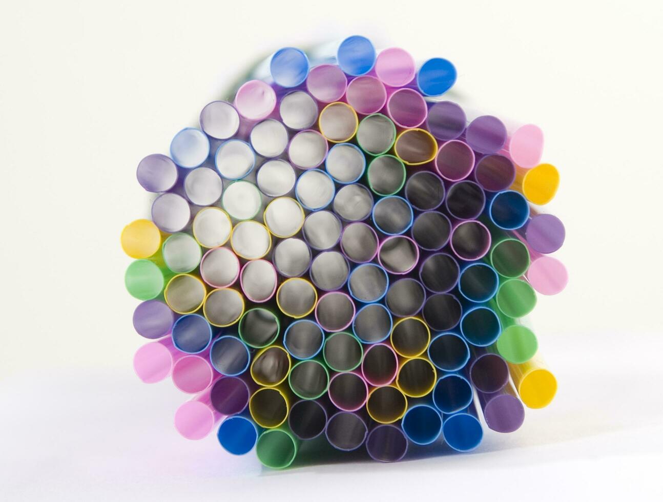 a bunch of colorful straws on a white background photo